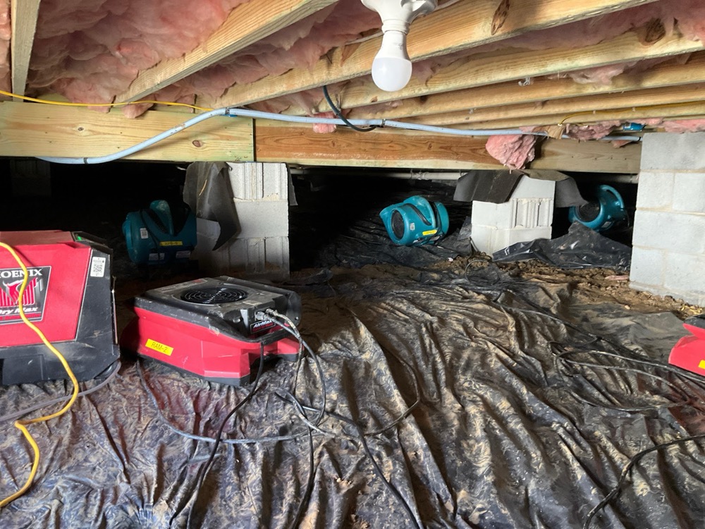 STOP Restoration drying equipment running on a vapor barrier inside a Carolina crawl space